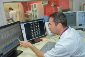 Medical Technician analysing scanner results to avoid medical interpreting errors