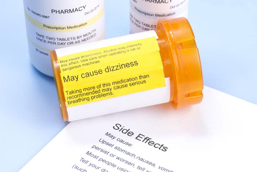 Prescription bottle with warning label and drug side effects print out to avoid mistranslated prescriptions